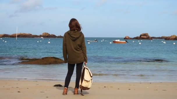 Girl with backpack on a beach — Stock Video