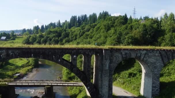 Hiker Girl Crossing Old Stone Bridge Mountain River Bright Summer — Stock Video
