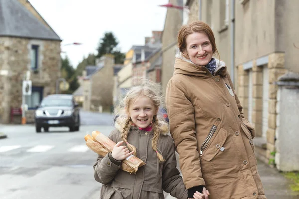 French happy mother and daughter with baguettes — ストック写真