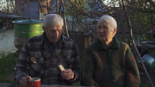 Senior Couple Sitting Outdoors Garden Rural House Eating Cake Quite — Stock Video