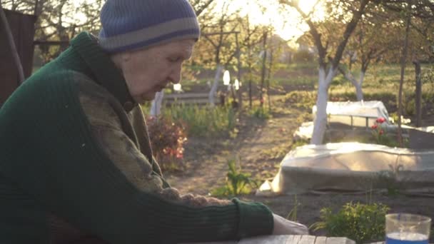 Senior Woman Sitting Outdoors Garden Rural House Quite Spring Evening — Stock Video