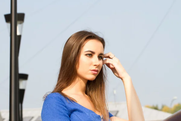 Girl in a blue dress in the modern city — Stock Photo, Image