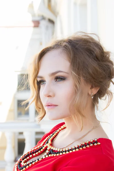 Beautiful young girl in a red dress — Stock Photo, Image