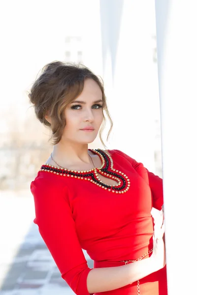 Beautiful young girl in a red dress — Stock Photo, Image