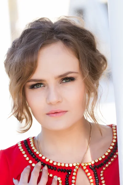 Beautiful young girl in a red dress — Stock Photo, Image