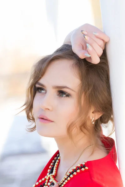 Beautiful young girl in a red dress — Stock Photo, Image