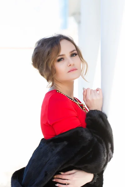 Beautiful young girl in a red dress — Stock Photo, Image