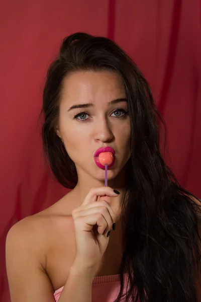 Young girl with lollipop posing on camera — Stock Photo, Image