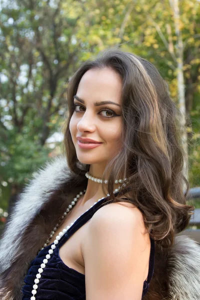 Kız sonbahar parkta bir bankta oturuyor