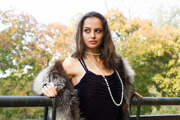 Girl in evening dress walks on autumn park — Stock Photo, Image