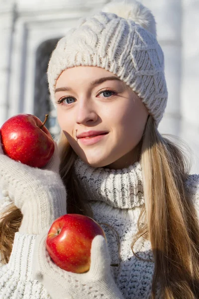 Blonde in a sweater with red apples. Winter portrait — Stock Photo, Image