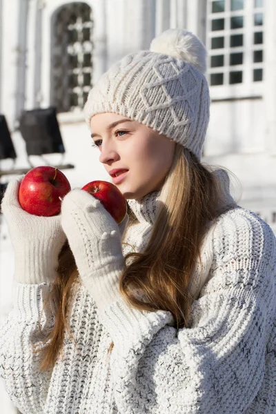 Blonde in a sweater with red apples. Winter portrait — Stock Photo, Image