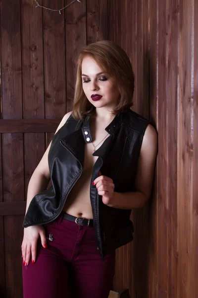 Beautiful young blond woman in a leather jacket on a naked body — Stock Photo, Image