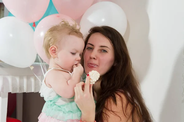 Mother with daughter eat cake