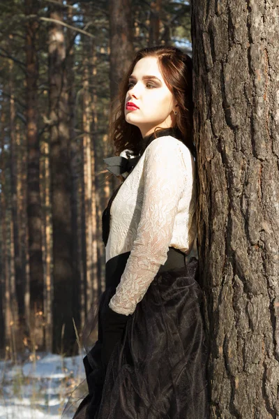 Girl in a long skirt in the winter forest — Stock Photo, Image