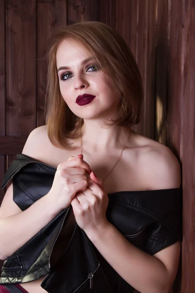 Young girl in a leather jacket and bright make-up — Stock Photo, Image