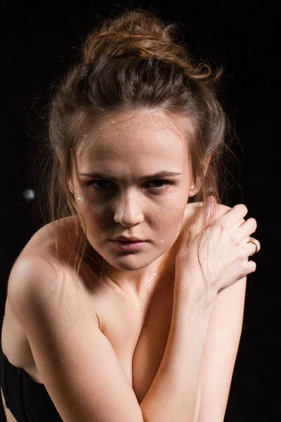 Studio portrait of a young girl on a black background — Stock Photo, Image