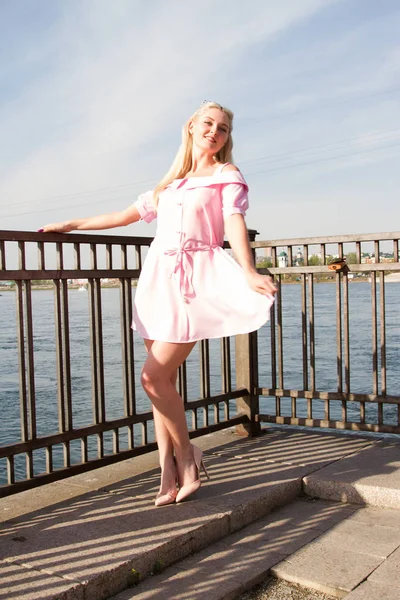 Jong meisje in korte jurk op de dijk van de rivier — Stockfoto