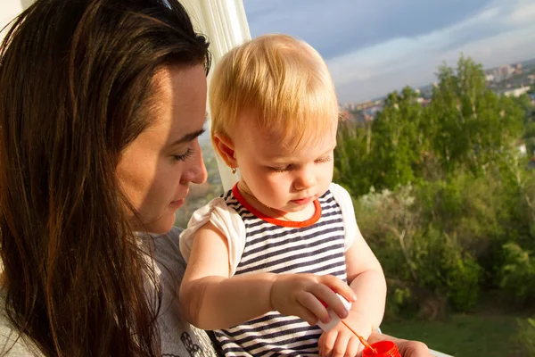 Mamá y su bebé dejaron las bolas de jabón desde el balcón — Foto de Stock