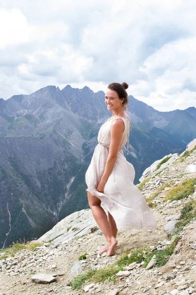 Girl in a dress on top of a mountain — Stock Photo, Image