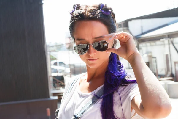 Girl with purple curls in denim overalls — Stock Photo, Image