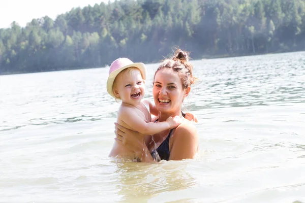 Щаслива мама і дитина купаються в річці — стокове фото