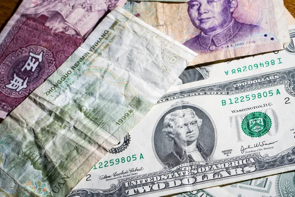 American dollars and Chinese yuan in small denominations — Stock Photo, Image