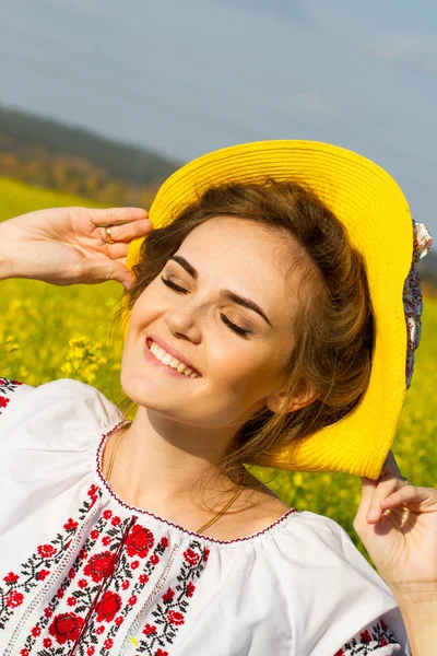 Young girl in an embroidered shirt stands among the fields — Stock Photo, Image