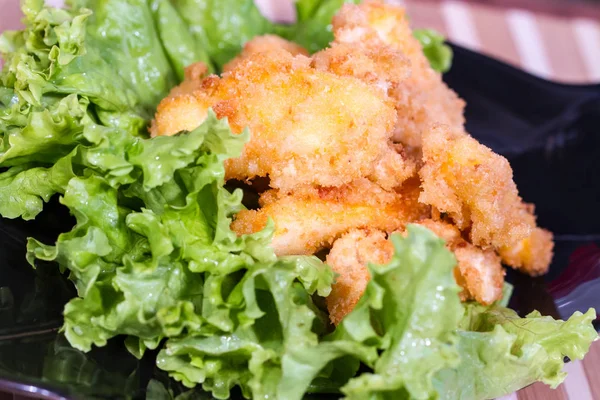 Appetizing meat in batter on a salad leaf — Stock Photo, Image