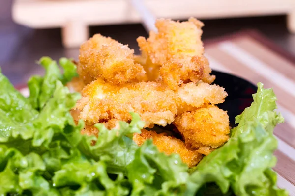 Appetizing meat in batter on a salad leaf — Stock Photo, Image