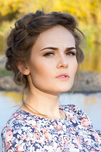 Slender young girl stands on the river bank — Stock Photo, Image