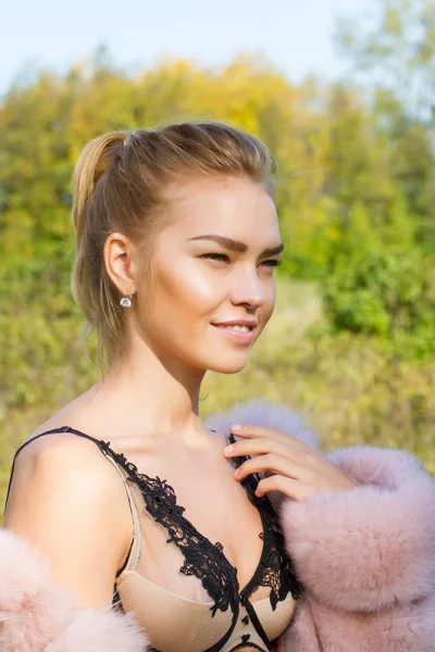 Blonde in lace underwear and pink coat — Stock Photo, Image