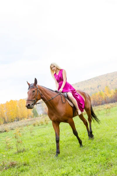 Girl with a horse walking in an autumn forest — Stock Photo, Image