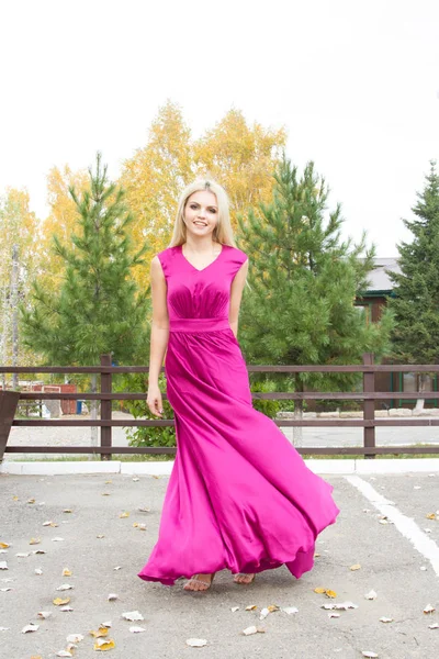 Beautiful blonde in a long evening dress — Stock Photo, Image