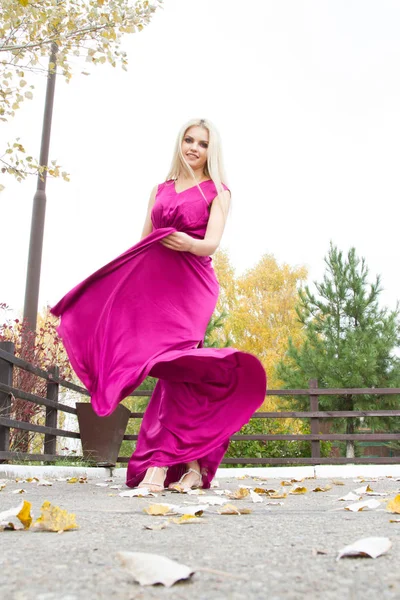 Beautiful blonde in a long evening dress — Stock Photo, Image