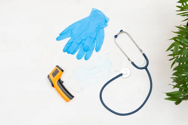 Medical concept. Medical supplies, gloves, digital thermometer, safety mask, stethoscope