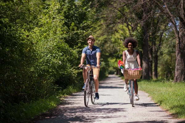 Unga multietniskt par att ha en cykel rida i naturen — Stockfoto