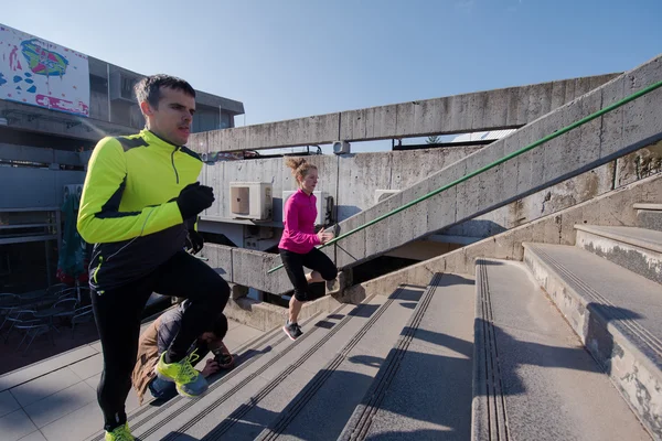 Giovane coppia jogging su gradini — Foto Stock