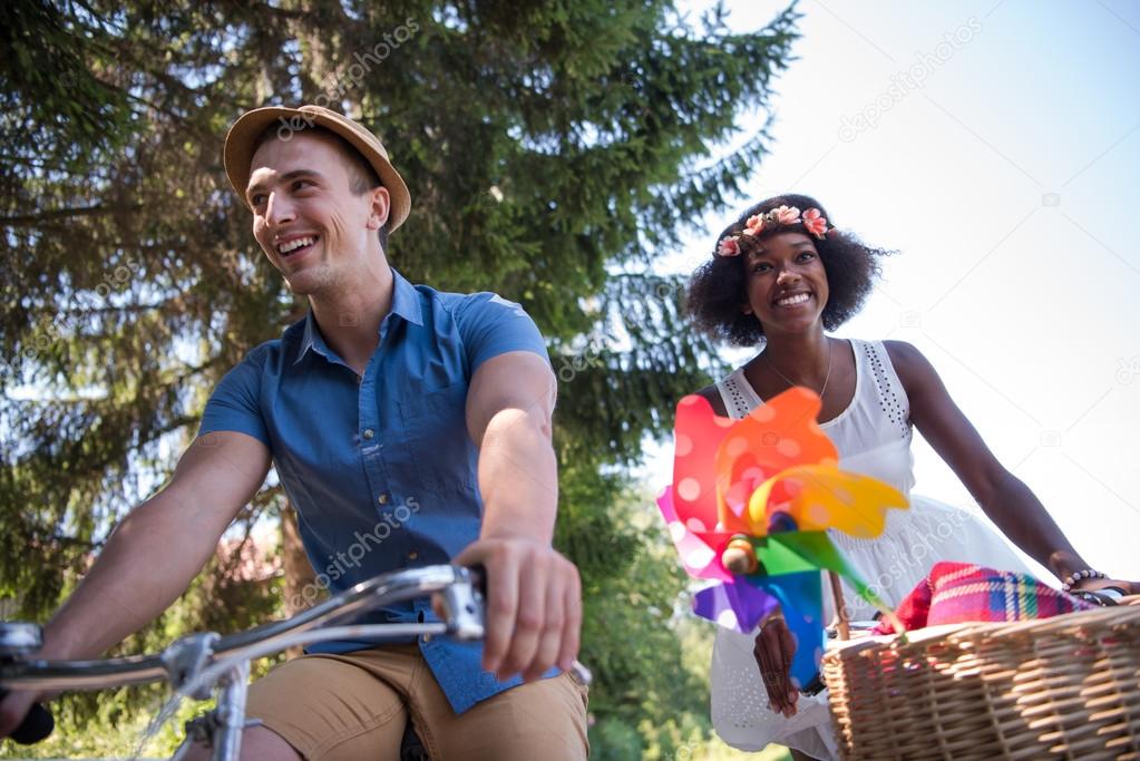 Young multiethnic couple having a bike ride in nature