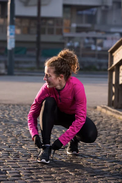 Žena, táhnoucí se před ranní jogging — Stock fotografie
