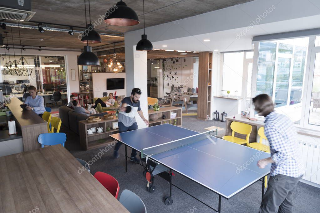playing ping pong tennis at creative office space — Stock Photo