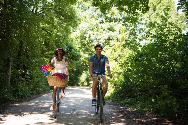 Jong koppel met vrolijke fiets rijden in de natuur — Stockfoto