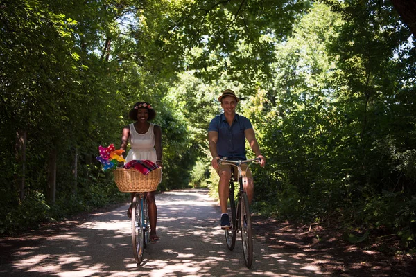 Jong koppel met vrolijke fiets rijden in de natuur — Stockfoto