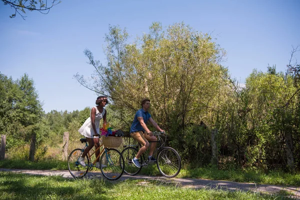 Young  couple having joyful bike ride in nature — Stock Photo, Image