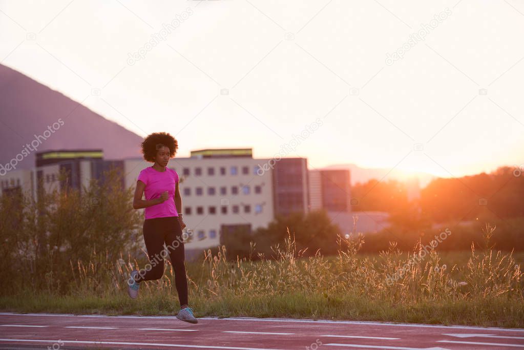 a young African American woman jogging outdoors