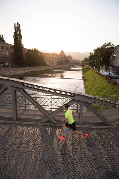 A young man jogging in the city — Stock Photo, Image