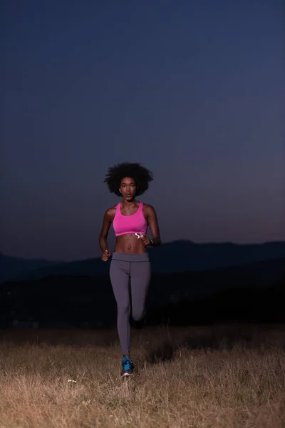 Young African american woman jogging in nature — Stock Photo, Image