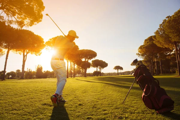Golf player hitting shot with club — стоковое фото