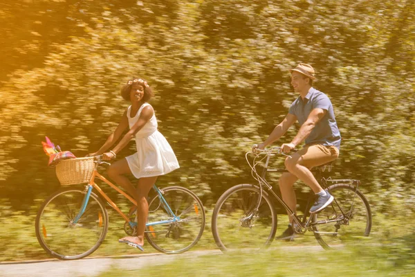 Jeune couple multiethnique faisant une balade à vélo dans la nature — Photo