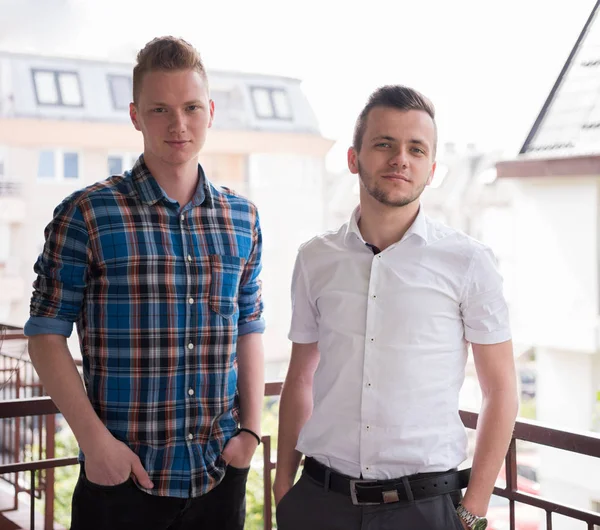 Two young men standing at balcony — Stock Photo, Image